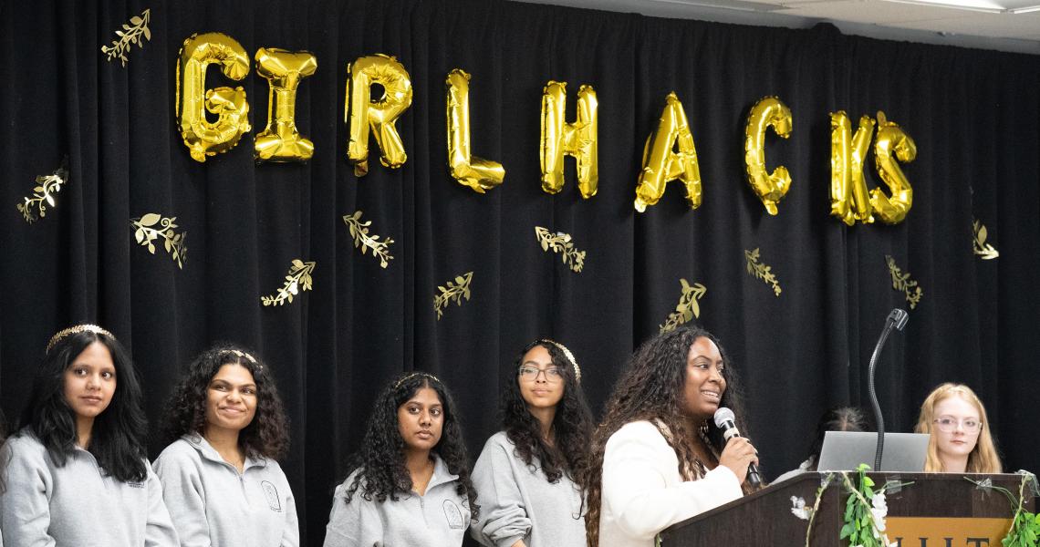 Girlhacks student hosts, on stage kicking off the event.