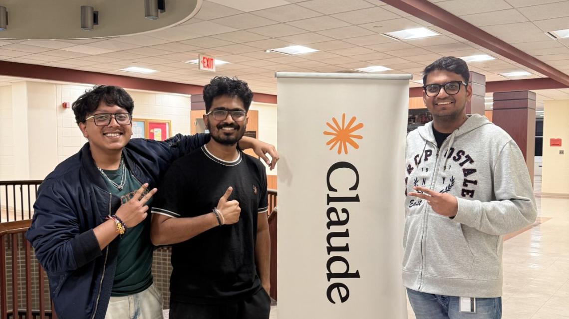 Students by a Claude banner